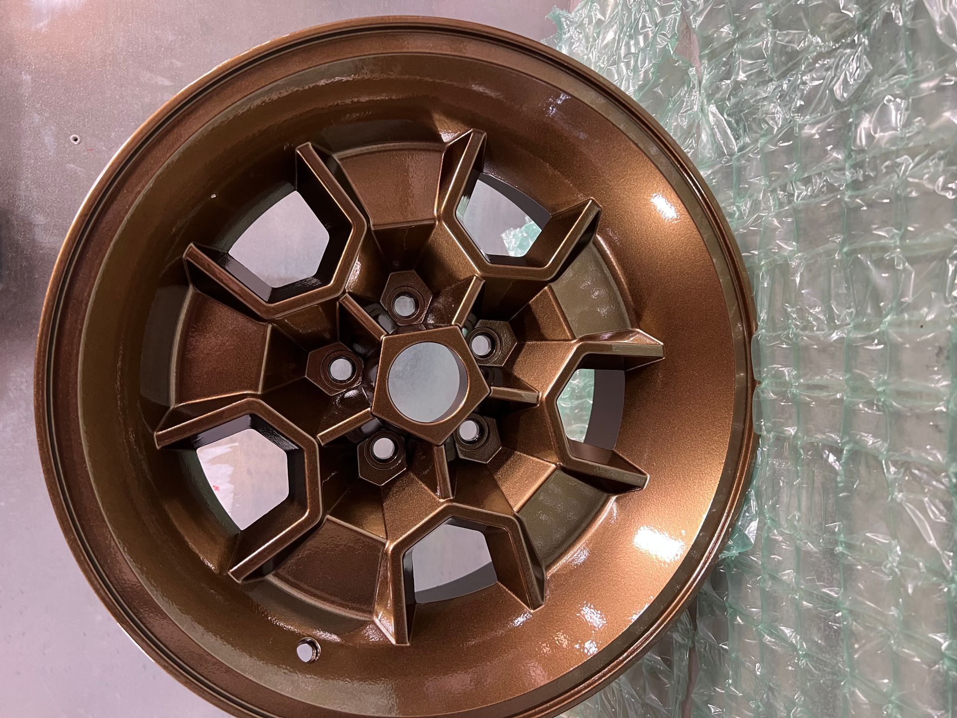 A close up of a wheel on a table. San Diego, CA โ Barrio Logan Powder Coating and Sandblasting