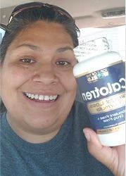 Woman smiling, holding a bottle of "Calotren" supplements.