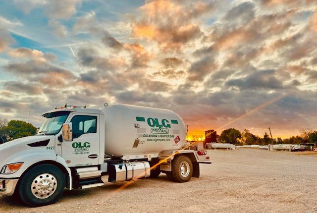 White OLC propane truck against a sunset sky.