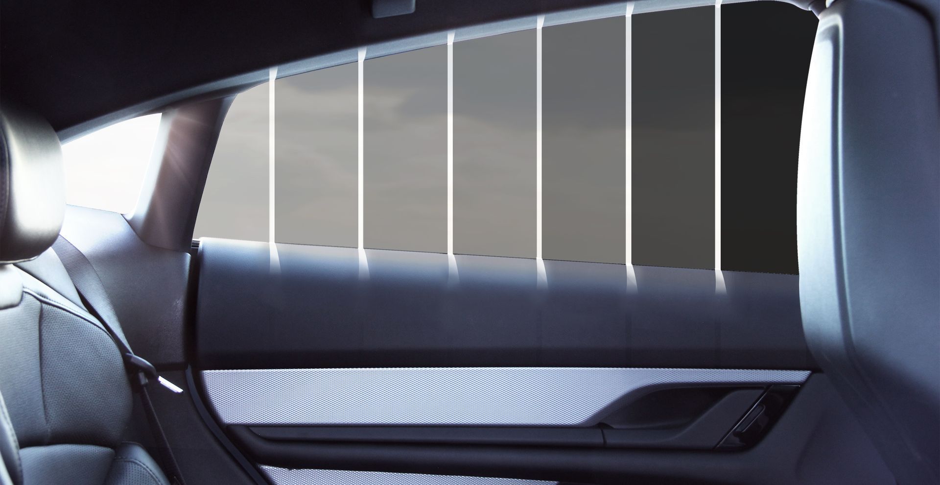The inside of a car with different shades of tint on the windows.