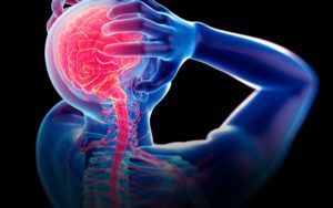 A person is holding their head in pain because of a headache.