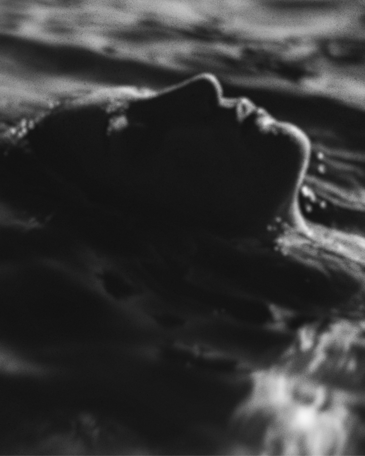 lady in the ocean, slightly blurred, black and white