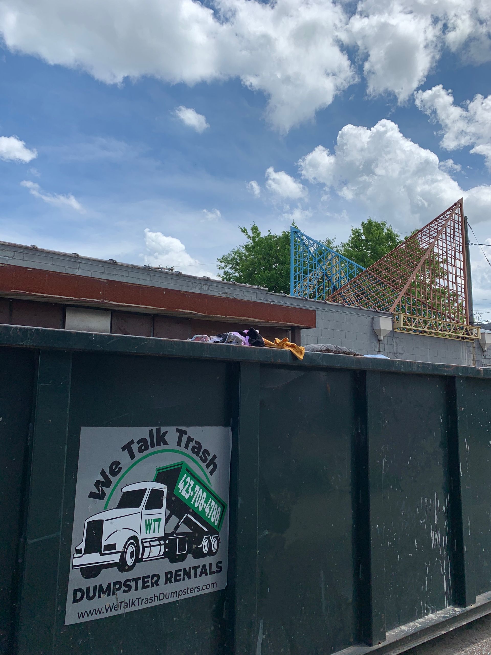 dumpster with we talk trash logo on it. 