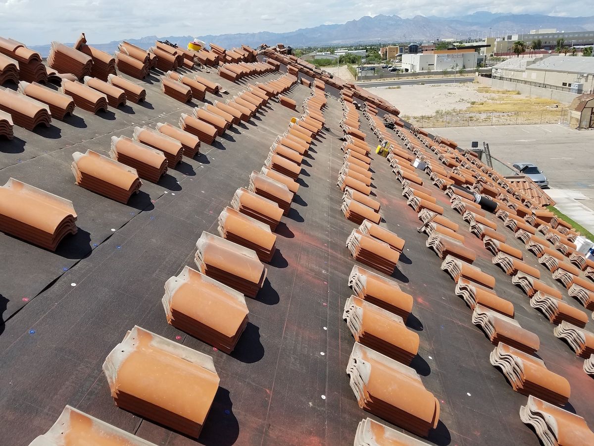 A roof with a lot of tiles on it ready for installation