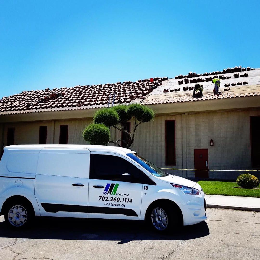 A white van is parked in front of a building
