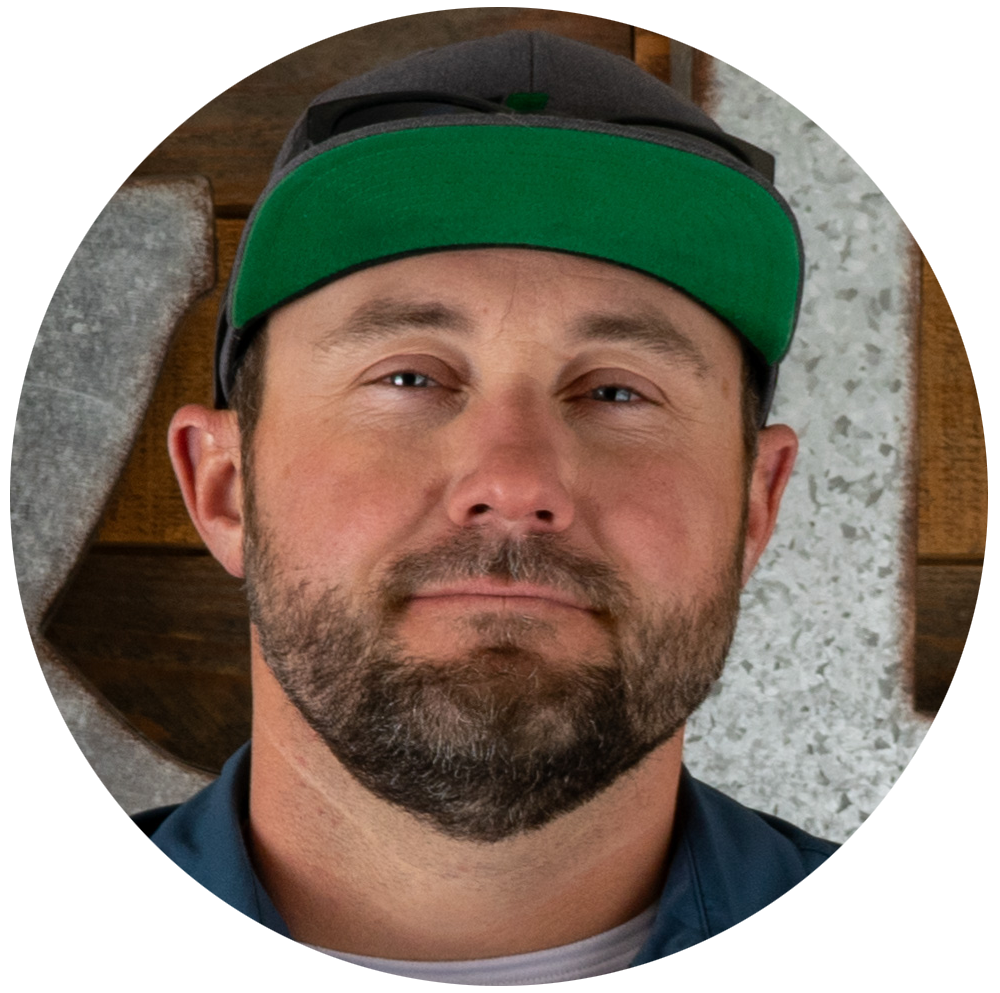 A man with a beard wearing a green hat