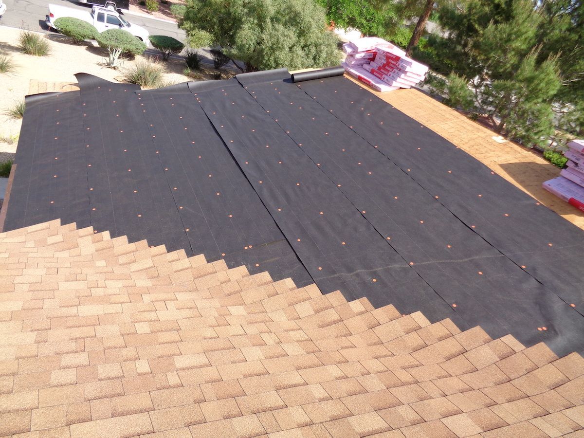 The roof of a house with shingles being installed
