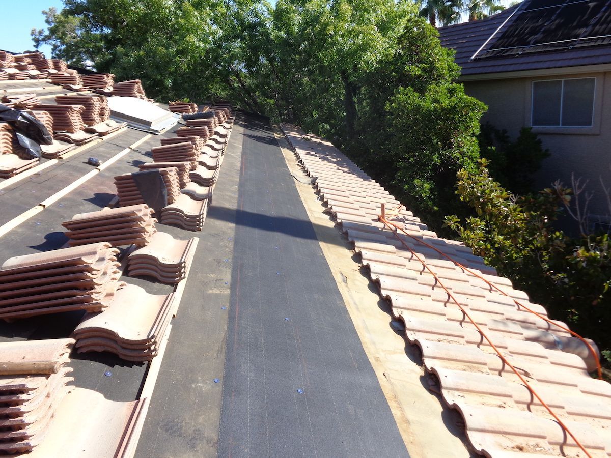 A roof with a lot of tiles on it ready for installation