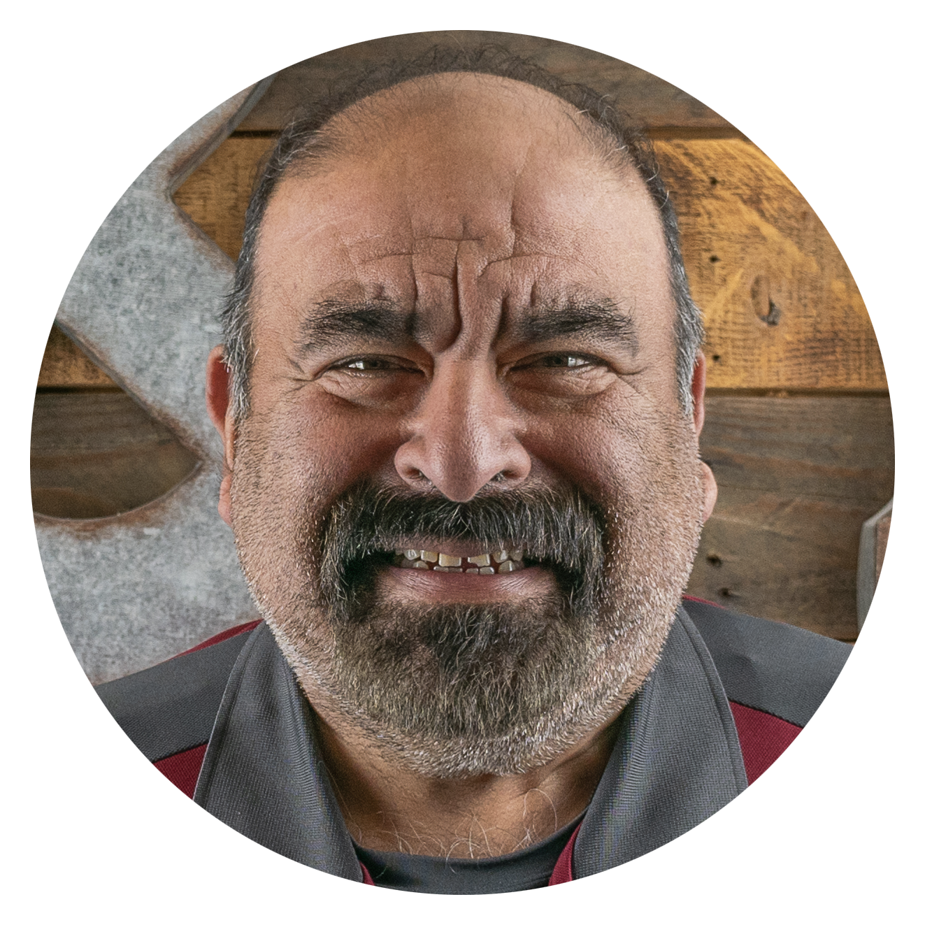 A man with a beard is smiling in a circle.