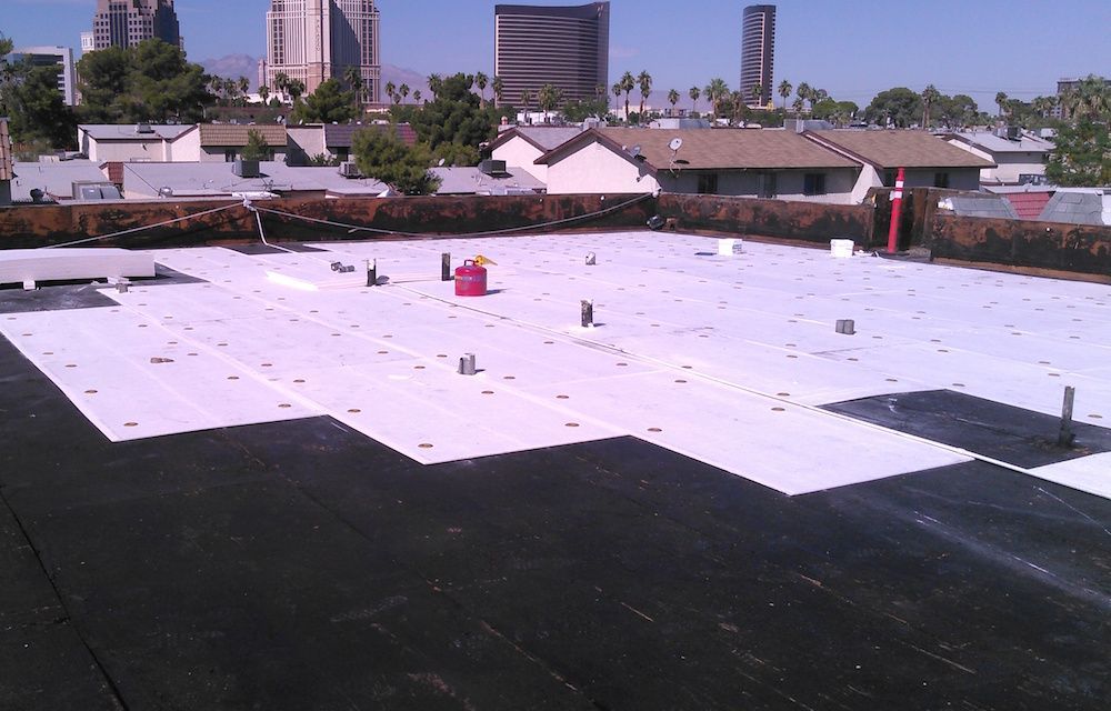 A black and white roof with a city skyline in the background