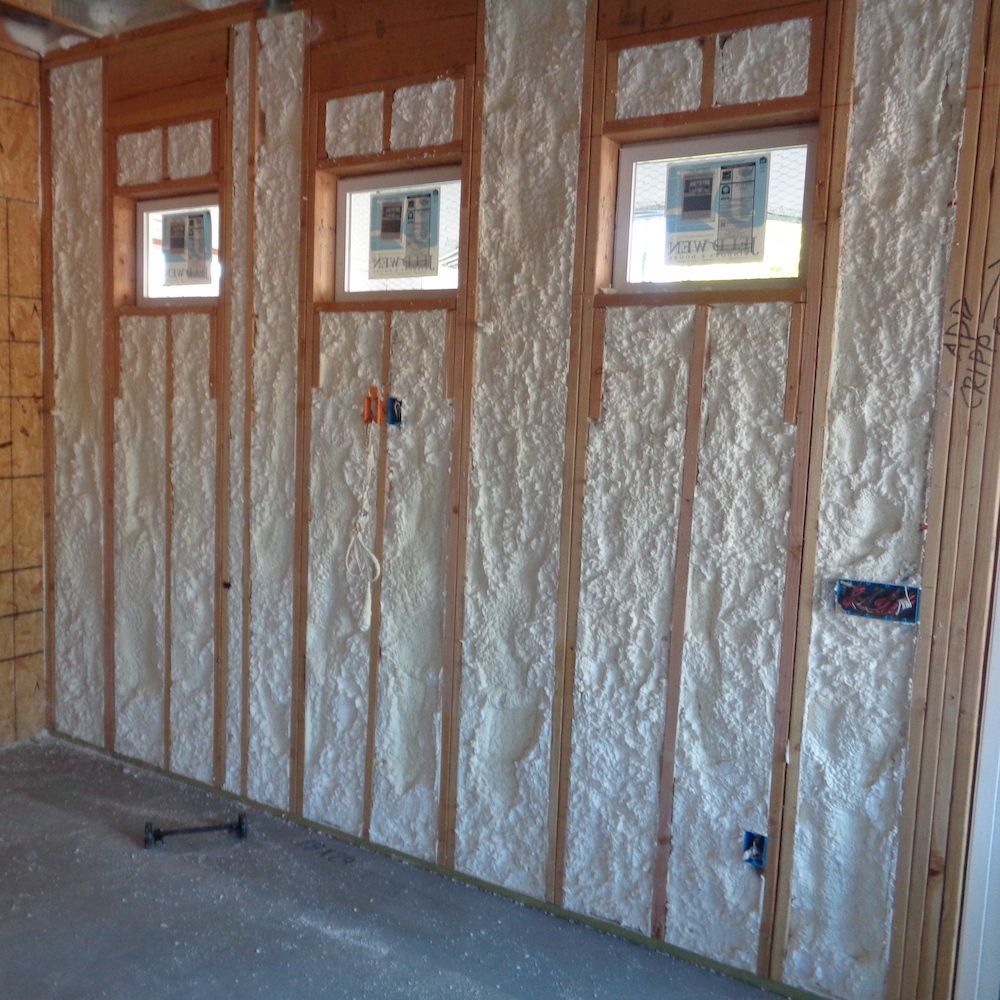 A room with foam insulation on the walls and windows