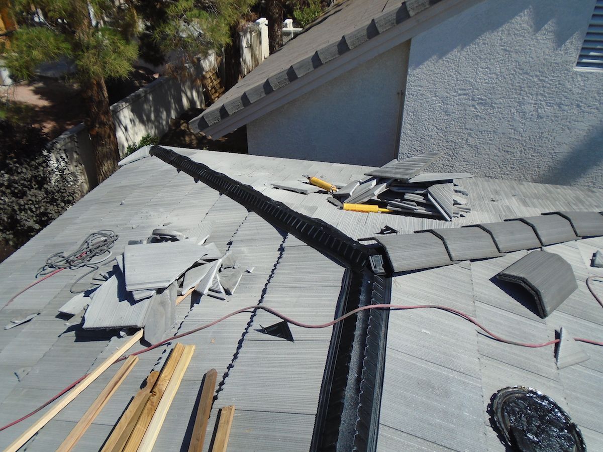 The roof of a house is being repaired with tools