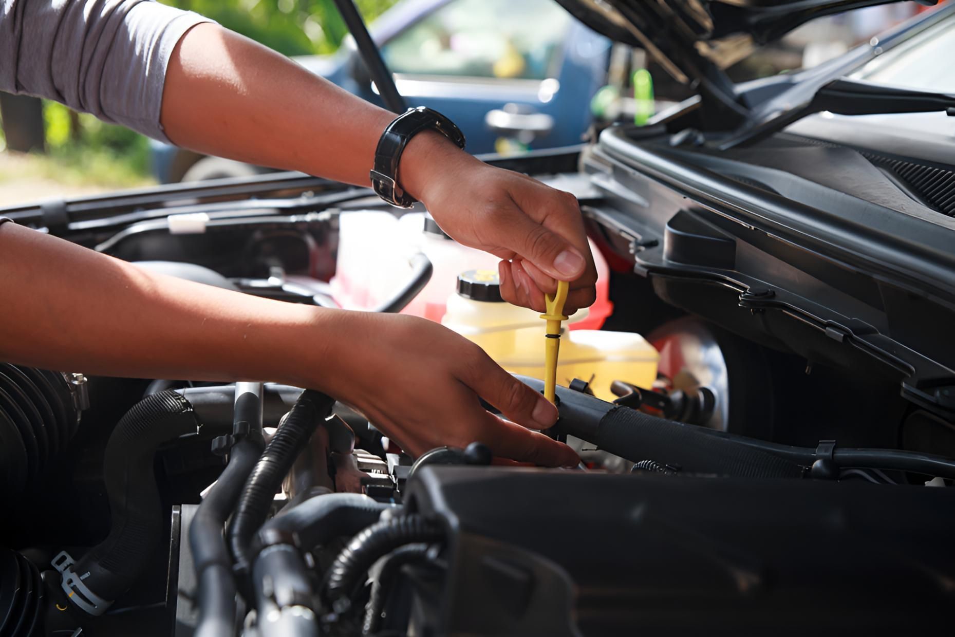 Person is Checking the Oil in a Car — Noosa Mechanical in Noosaville, QLD