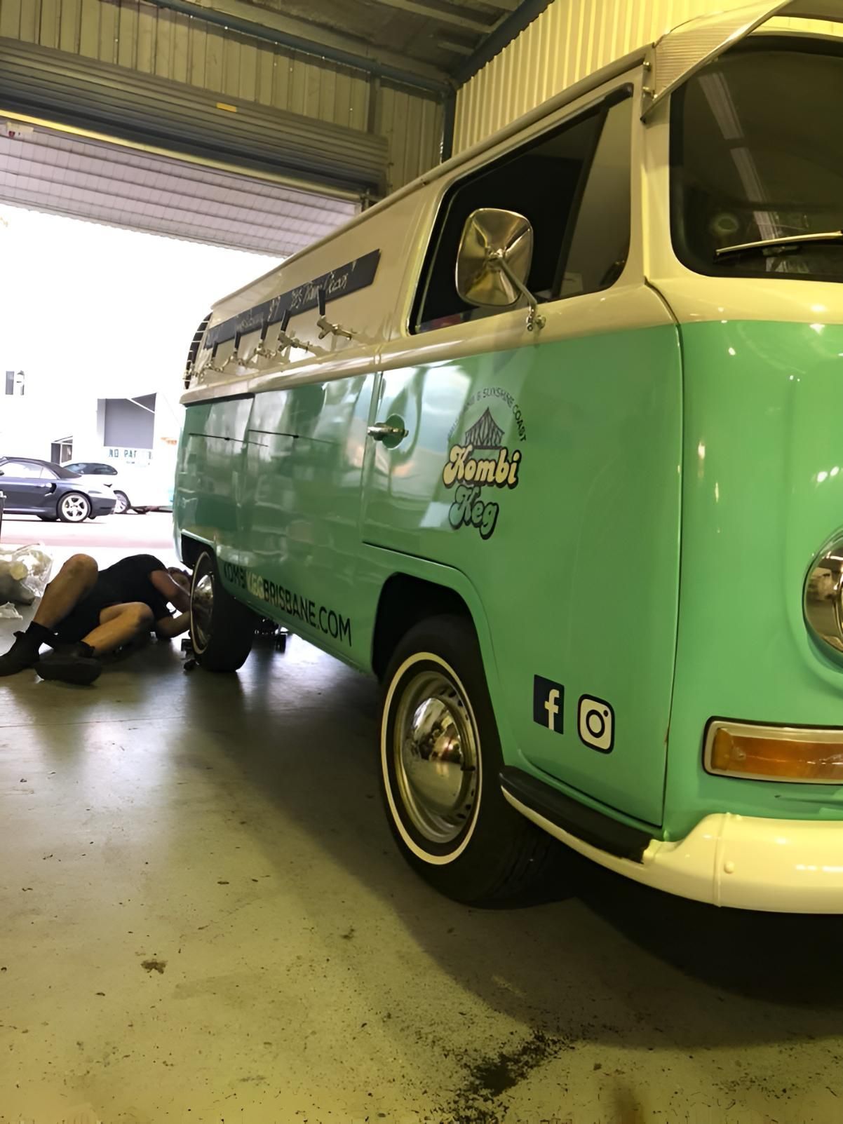 Man Inspecting Green and White Van in a Garage — Noosa Mechanical in Noosaville, QLD