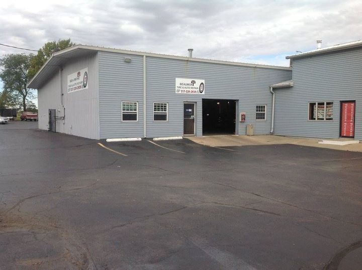 A large grey building with a white sign that says ' automotive ' on it