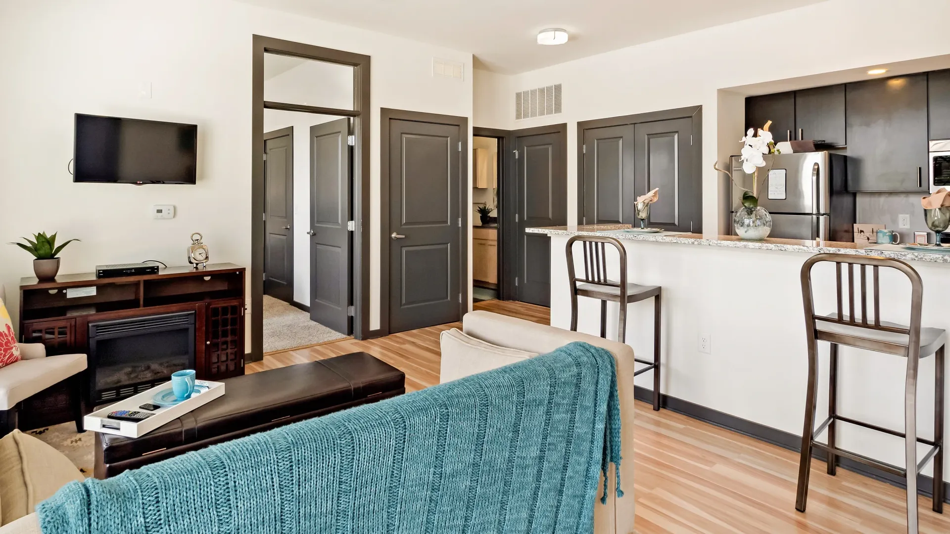 Living room and kitchen area with bar seating.