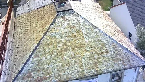 View of a weathered, worn roof with discoloration.