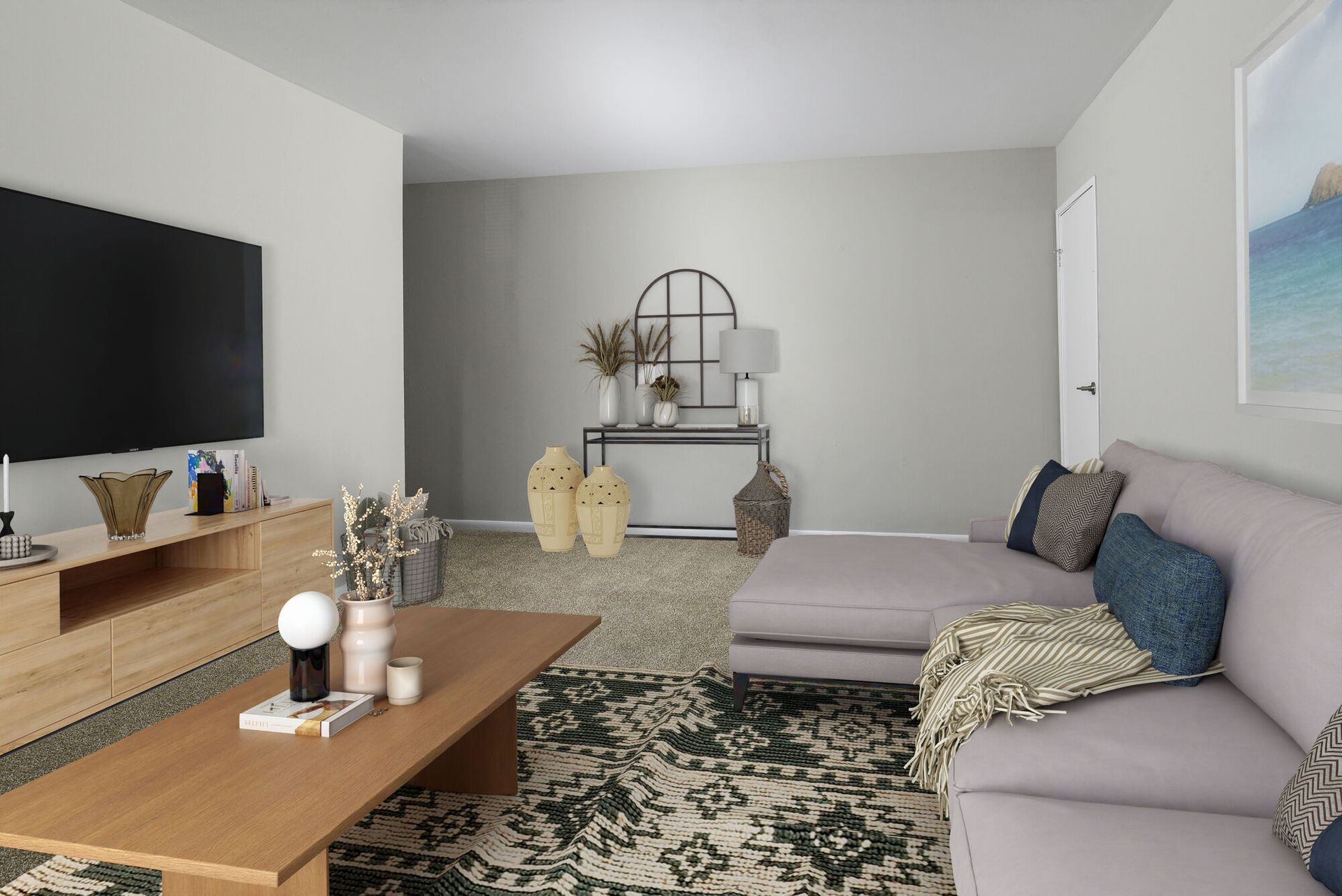 Living room with gray walls, sofa, TV, wooden furniture, and patterned rug.