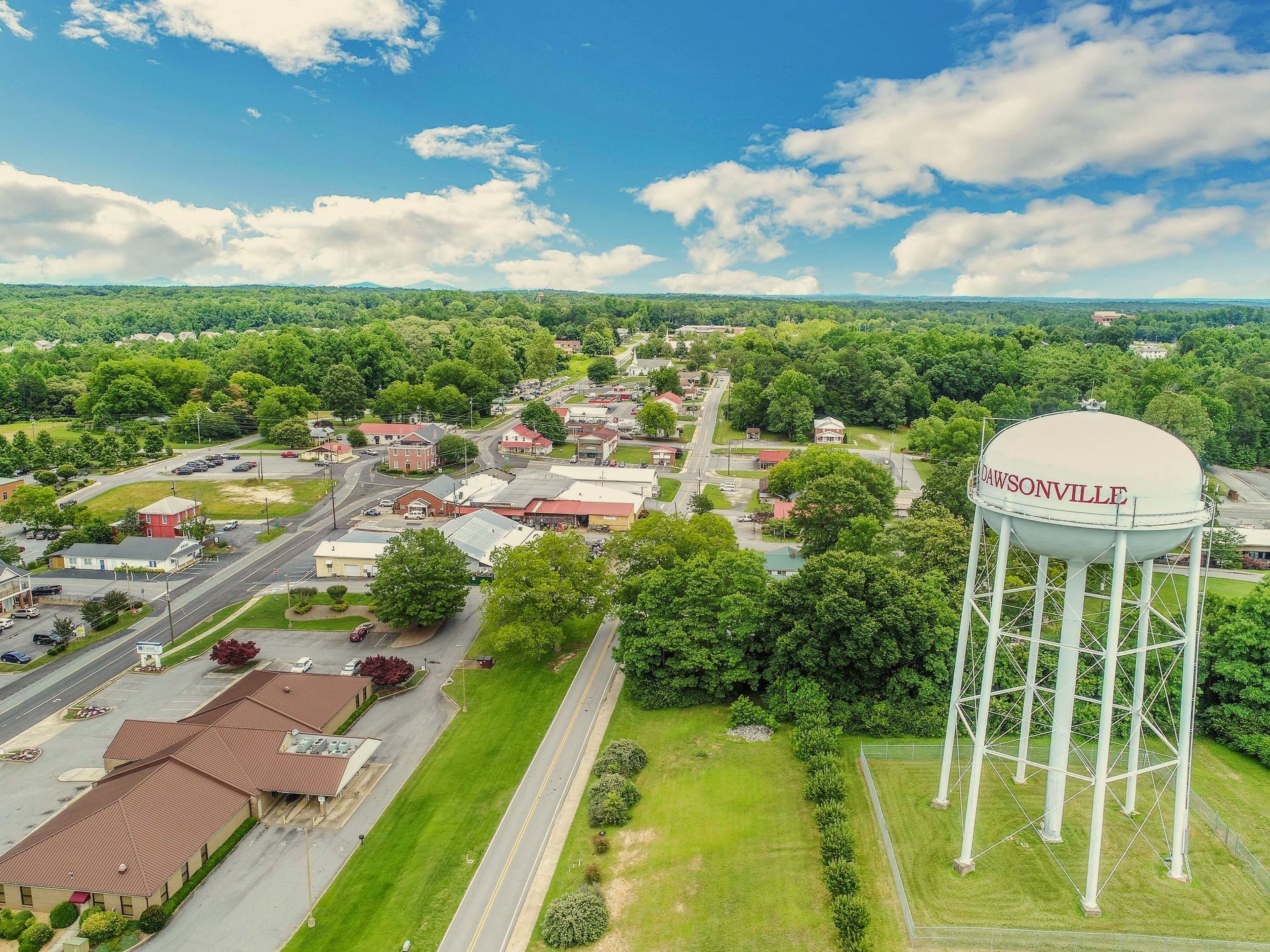 An aerial view of a small town with a water tower in the middle of it.