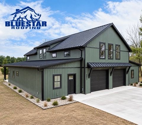 Modern green metal-roofed house with a concrete driveway and BlueStar Roofing logo in the corner