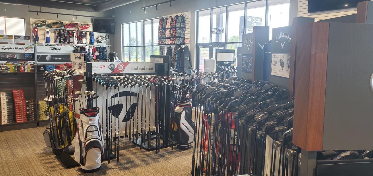 A golf store filled with lots of golf clubs and bags.