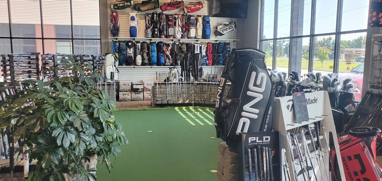 A golf store with a lot of golf clubs on display.
