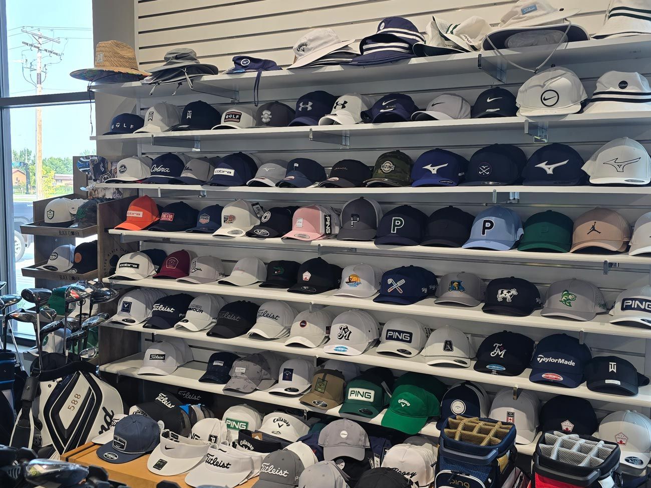 A store filled with lots of hats and golf bags.