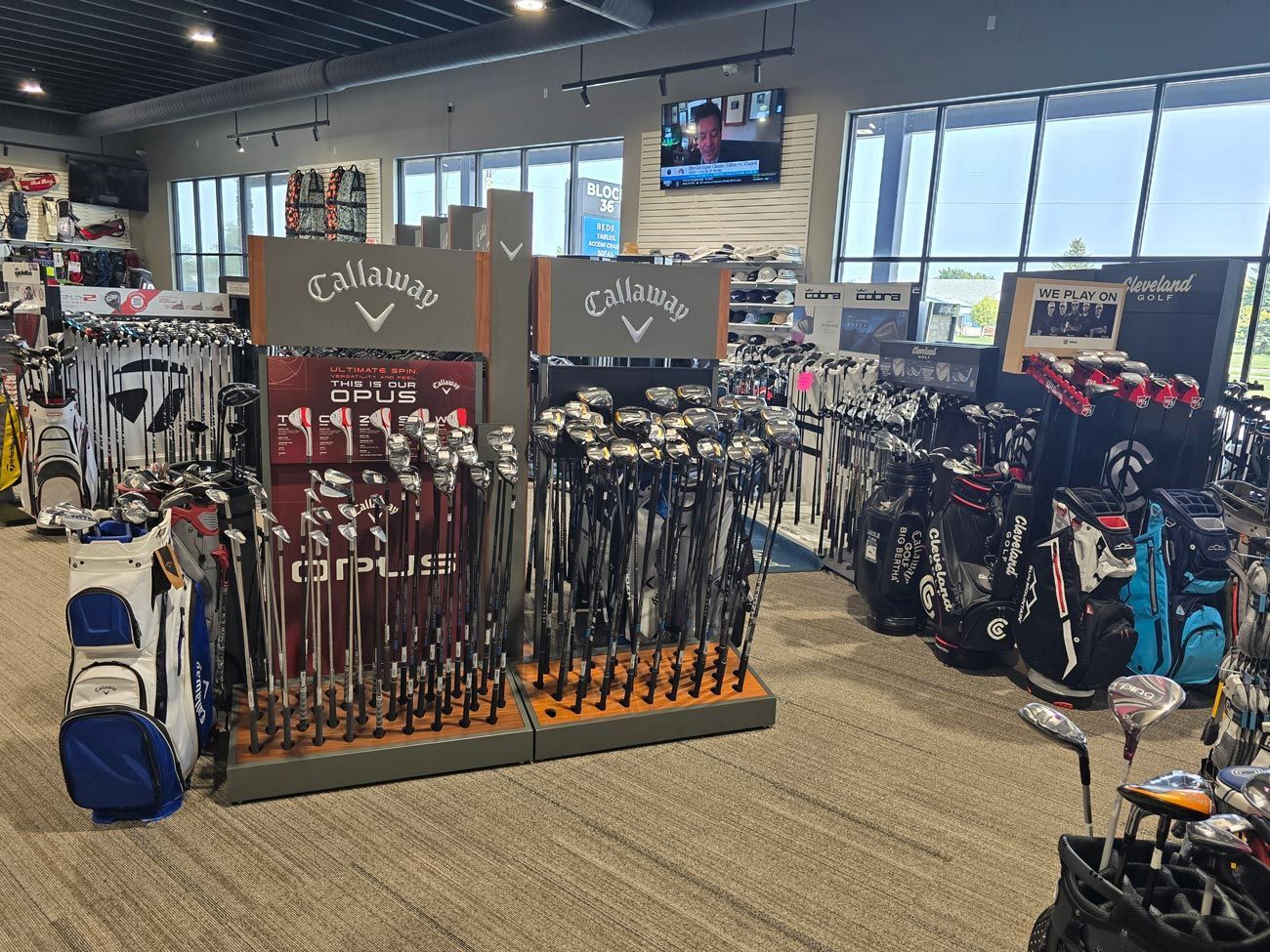 A golf store filled with lots of golf clubs and bags.