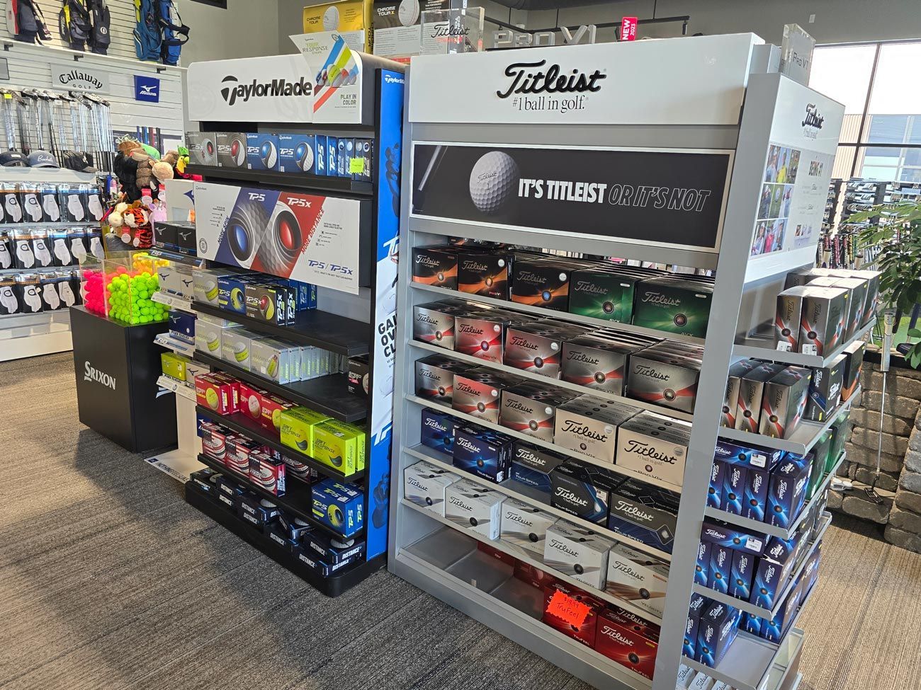 A display case filled with lots of golf balls in a store.