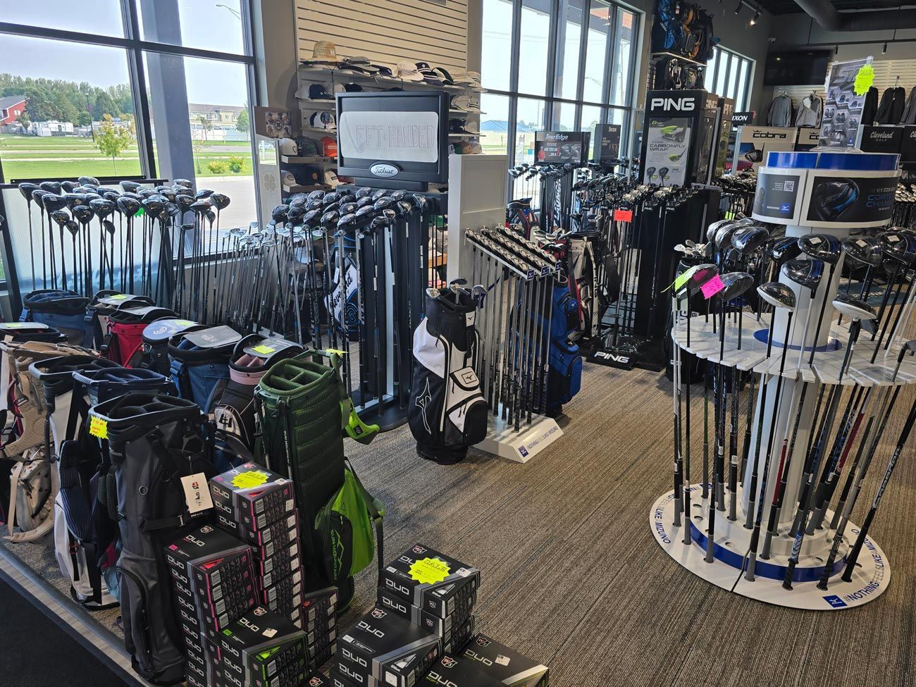 A golf store filled with lots of golf clubs and bags.