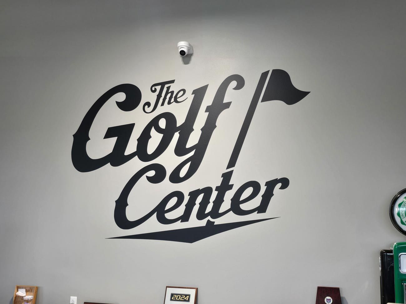 The golf center logo is painted on a wall