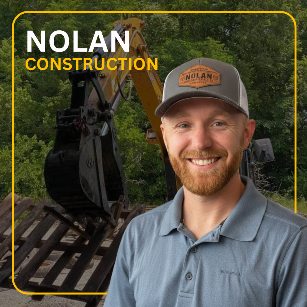 a small excavator is driving down a gravel road .