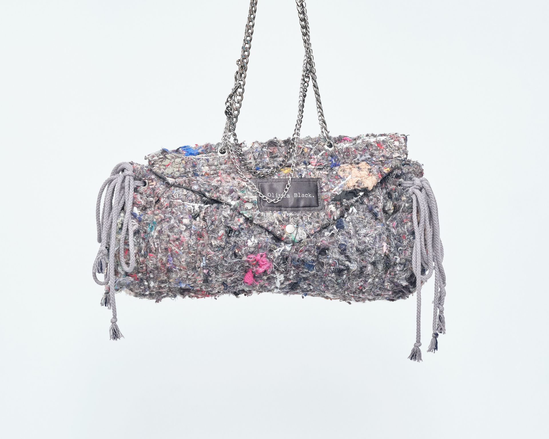 A purse with a chain hanging from it on a white background.