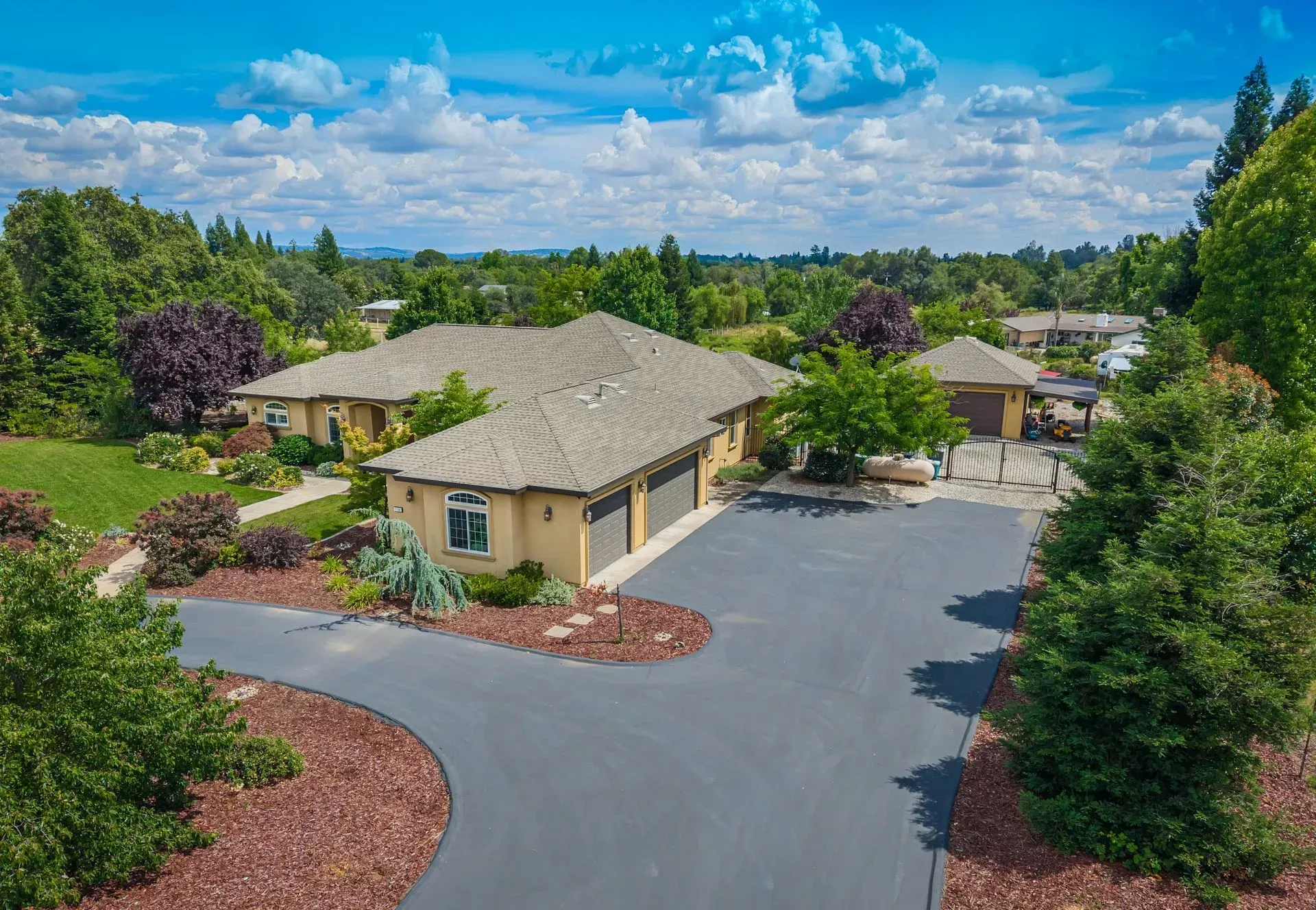 Large paved circular driveway and attached garage area of the custom home at 7190 Starkview Pl, a Loomis, CA home for sale.