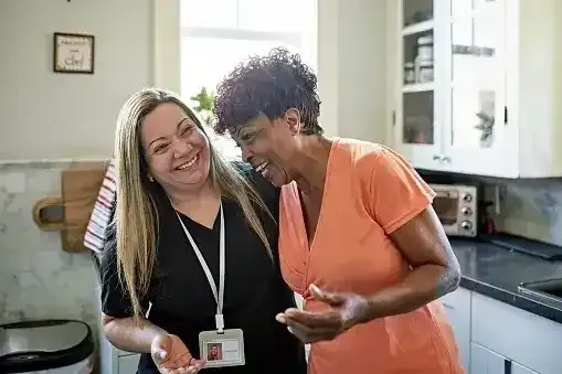 Caregiver having a good laugh with an elderly homecare client