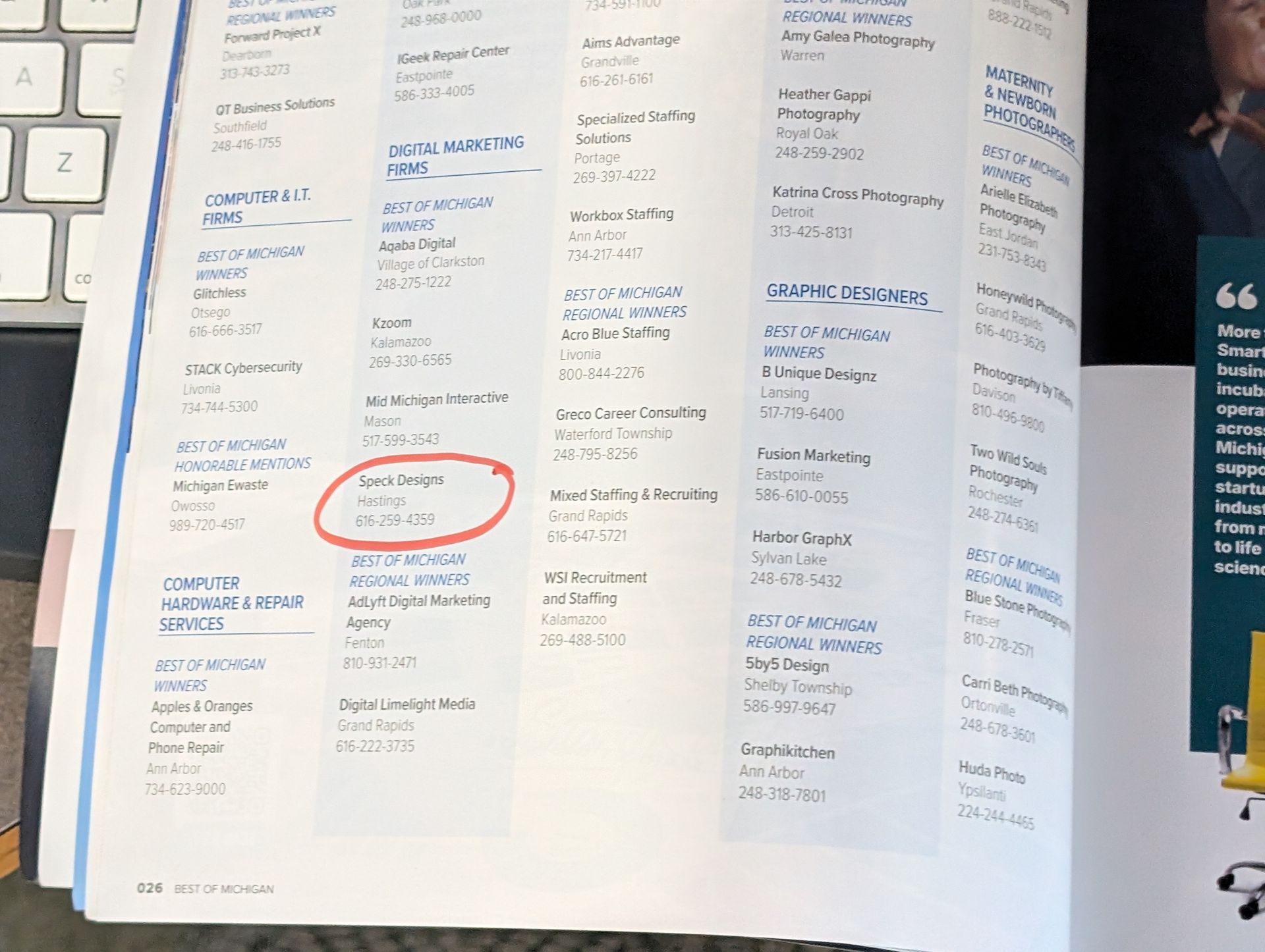 Open magazine spread with columns of text; a red circle marks an item in the lower left page.