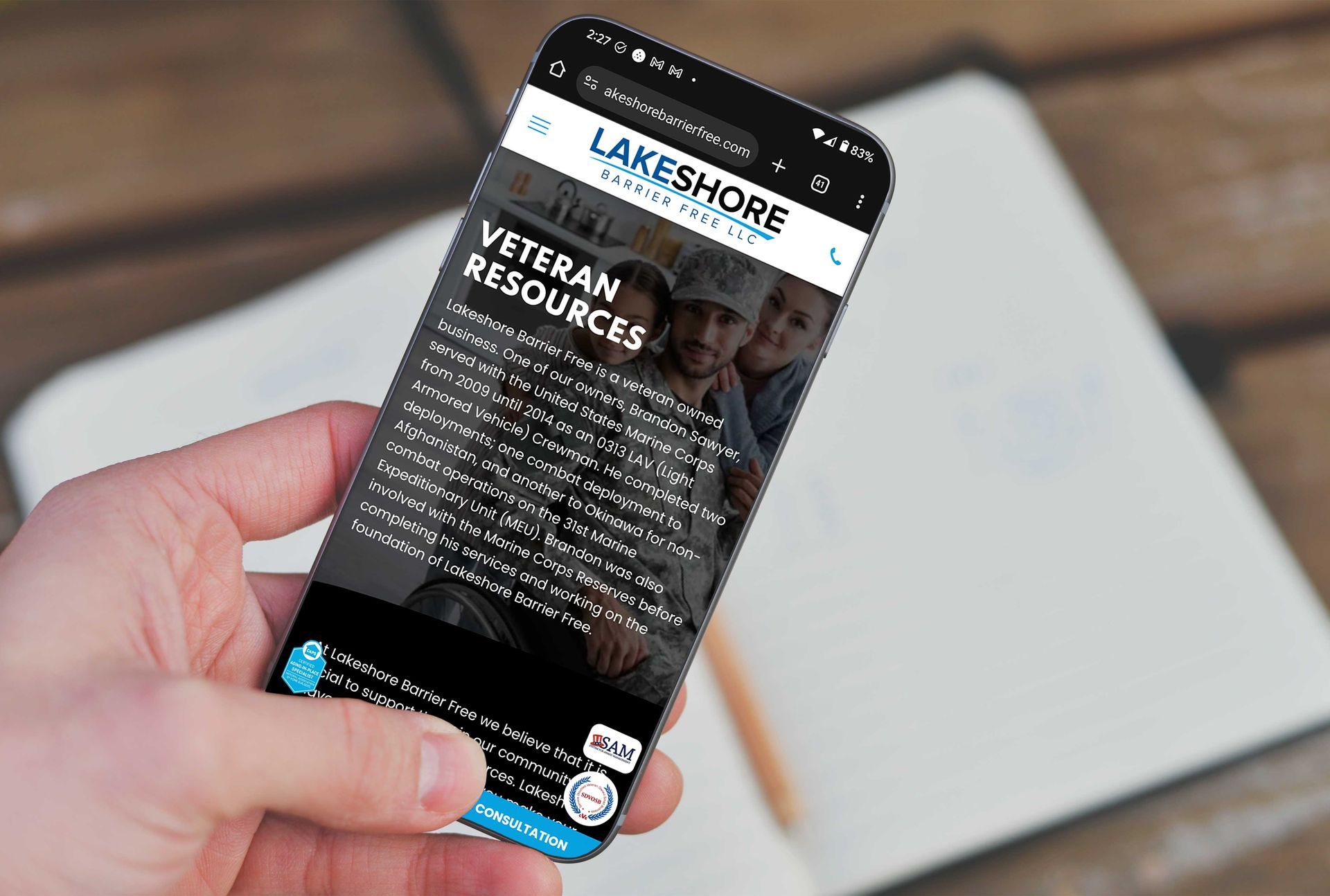 A hand holds a smartphone displaying the 