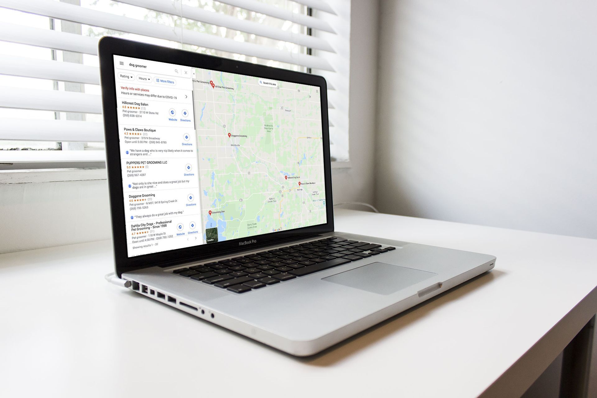 A laptop computer is open to a map on the screen to show SEO techniques.