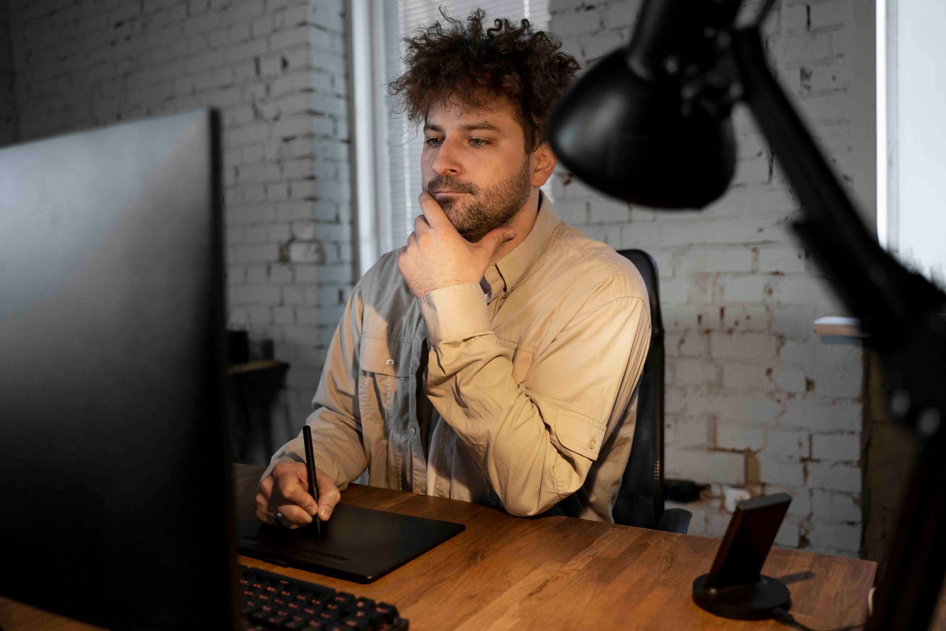Photo by Freepik A man is sitting at a desk in front of a computer.
