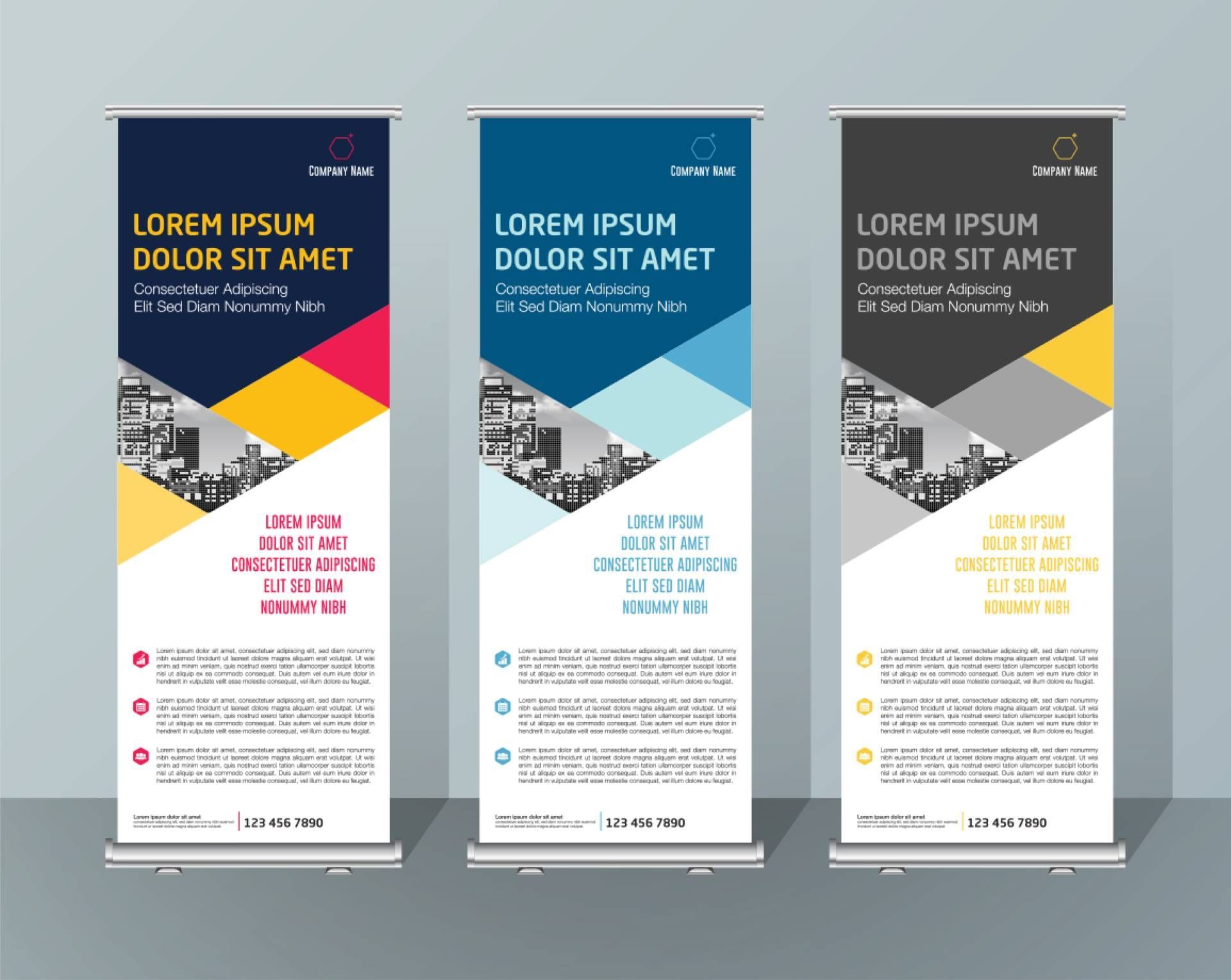 A set of three roll up banners with a city in the background.