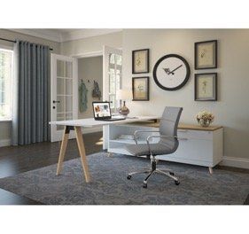Home office with a white desk, gray chair, and decor on the wall.
