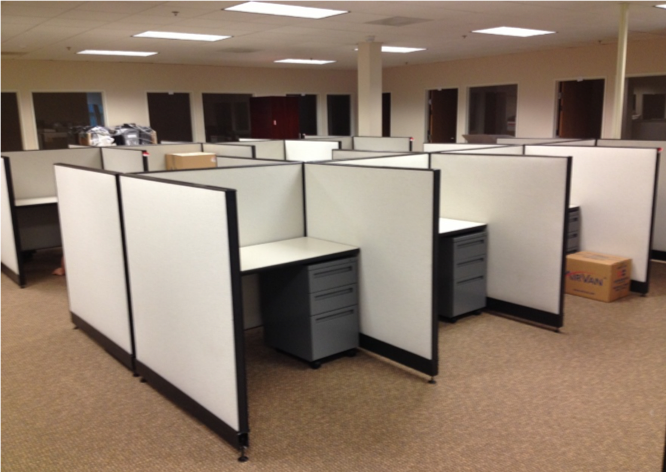 Modern office cubicles with desks, chairs, and computer monitors. Includes height comparison for male and female figures.