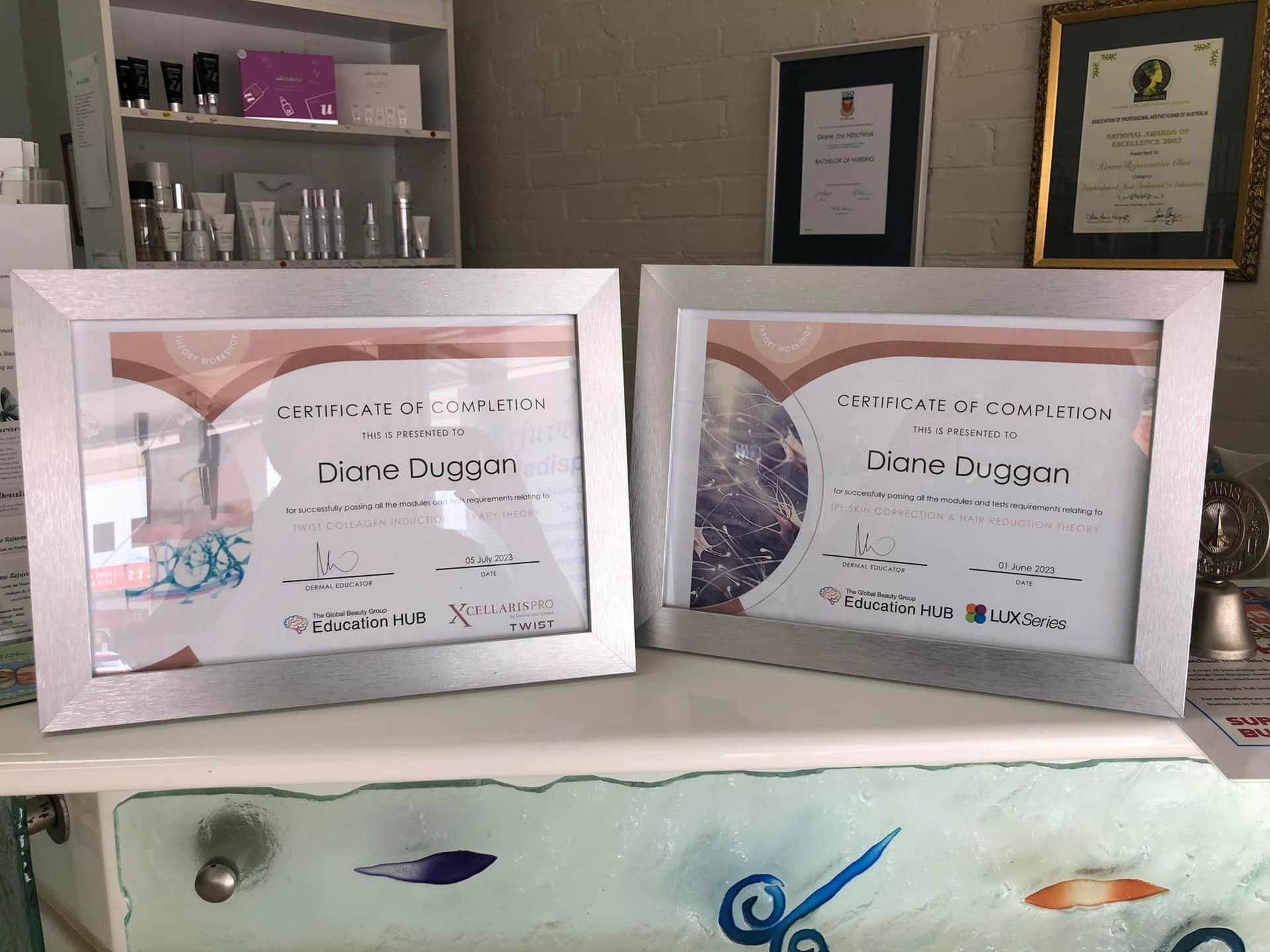 Two Framed Certificates Are Sitting On A Counter — Xtreme Rejuvenation Clinic, Medispa & Beauty Therapy In Maryborough, QLD