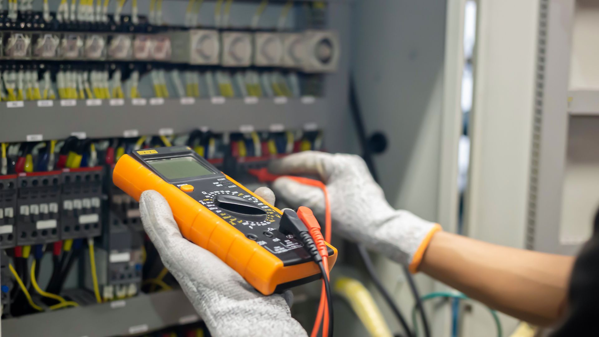 Electrician inspecting home electrical panel during emergency repair