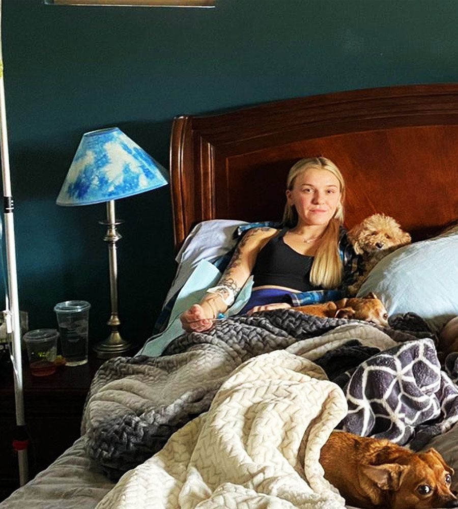 Pregnant woman receiving mobile IV therapy for morning sickness relief at home