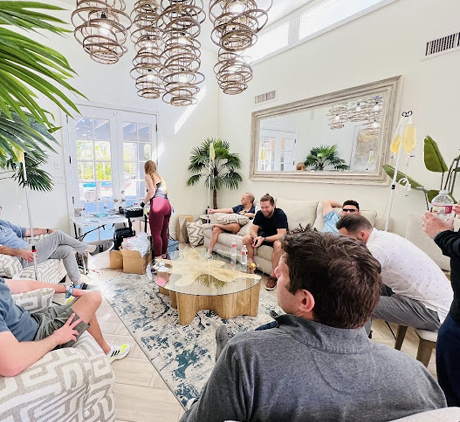 Multiple patients receiving IV therapy at home in a comfortable setting.
