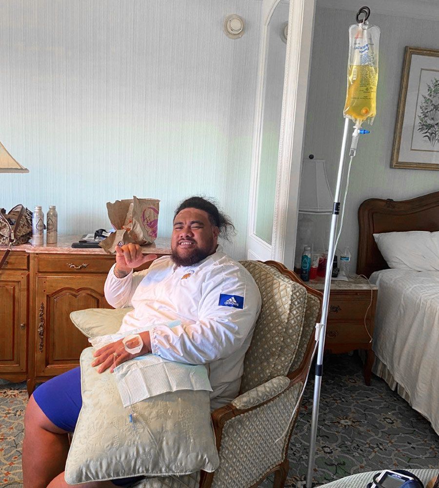 A man wearing an Adidas jacket receiving am allergy iv drip IV treatment.