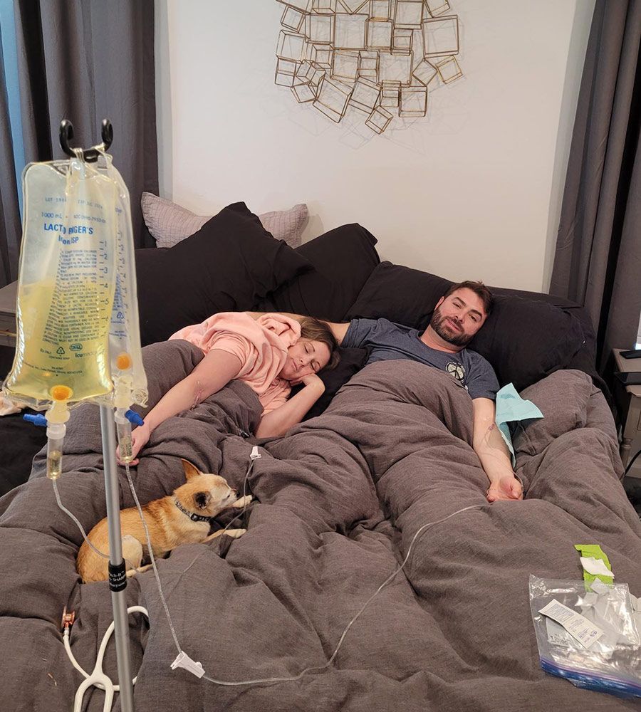 Couple receiving mobile iv therapy for allergy relief at home.