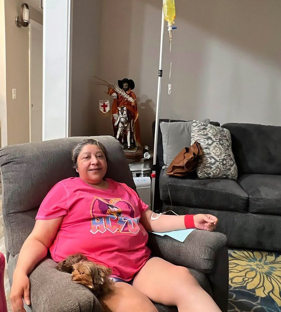 Woman Receiving IV therapy for digestive issues on her couch