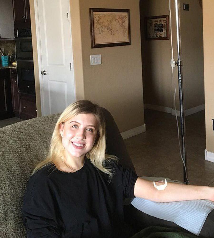 A patient resting on a comfortable living room couch during an iv drip for energy session.